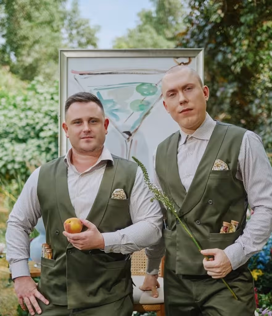 Two men in green vests